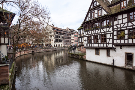 STRASBOURG, FRANCE - DECEMBER 11, 2011: people on waterfront of Ill river canal in old Strasbourg town.のeditorial素材