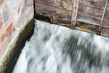 detail at small Wooden dam on a mountain river .の写真素材
