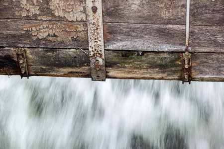 detail at small Wooden dam on a mountain river .の写真素材