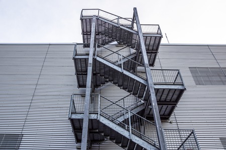 Abstract industrial architecture fragment on blue sky background, metal stairway sections