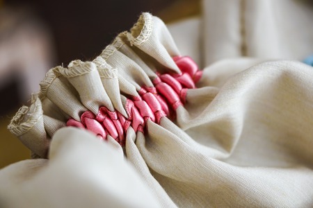 close up off small bag whith decorative pink stitching pregnancy annoucement concept.の写真素材