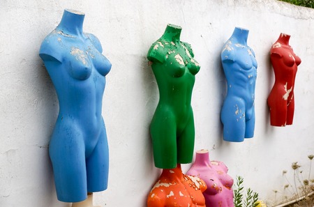 colored mannequins . dummies . old mannequins abandoned his a wall of a buildingの写真素材