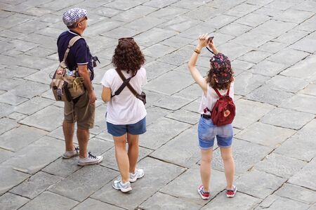 Verona, Italy - September 5, 2018: tourist taking a photo of the famous Verona Arena, a Roman amphitheatre in Piazza Bra in Verona, built in the first century. Selective focusのeditorial素材
