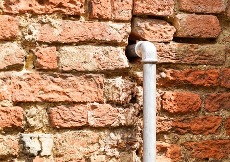 White pipe on wall background, pipe for water system and electricity system on brick wall