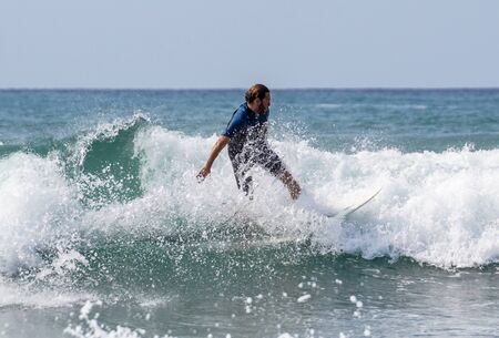 Italy Tuscany sea 18 July 2018 : Surfing on the north shore . Man at surf in italy .