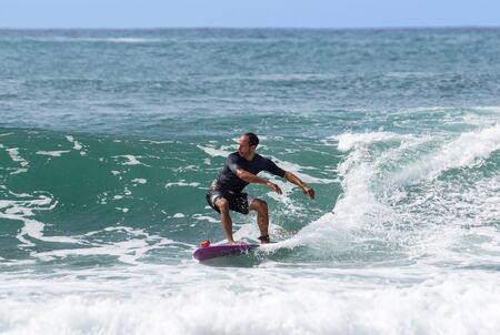 Italy Tuscany sea 18 July 2018 : Surfing on the north shore . Man at surf in italy .