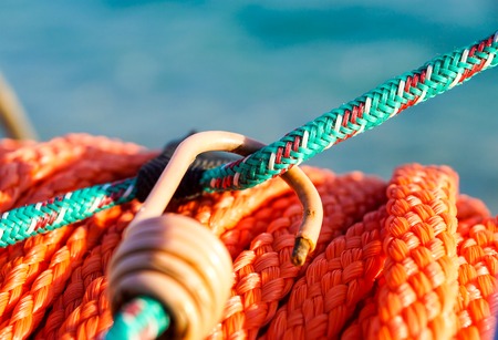 hanging orange life belt with long rope at the beach, security and safety conceptの写真素材