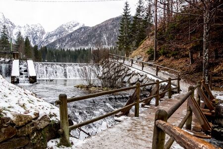 Waterfall trailing through deep woodsの写真素材