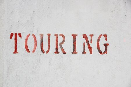 touring sign written on wall . close up .の写真素材