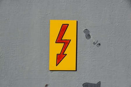 Danger Electrical Hazard High Voltage Sign on wallの写真素材