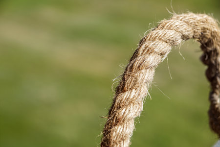 details straw rope knot on green background