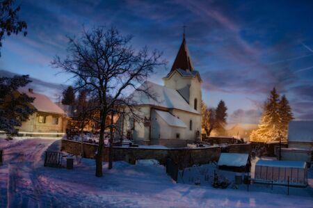 Village church on a winter nightの写真素材