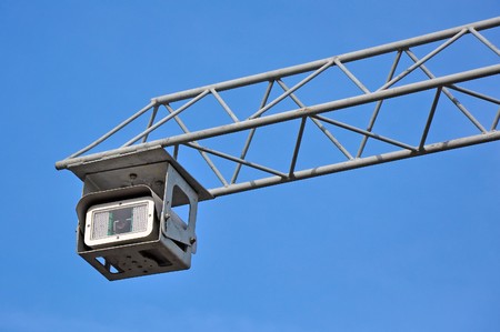 Road police supervision outdoor video camera against blue sky