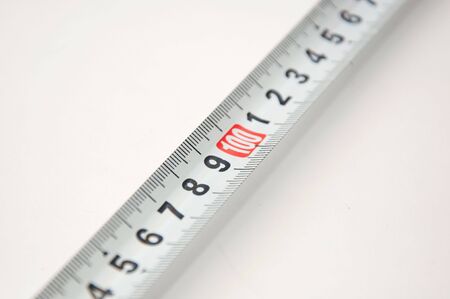 Red tape measure meter over a white background