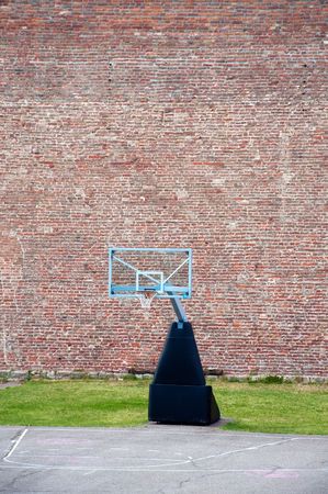 Basketball hoop and an empty outdoor court.の写真素材