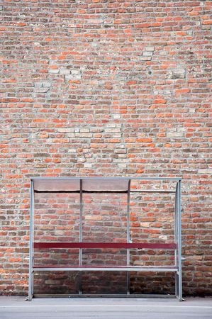 Bench againt a brick wall; urban sceneryの写真素材