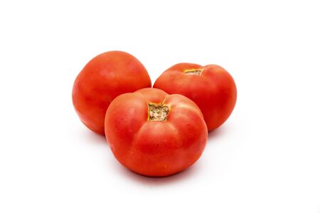 Three tomatoes isolated on white backgroundの写真素材