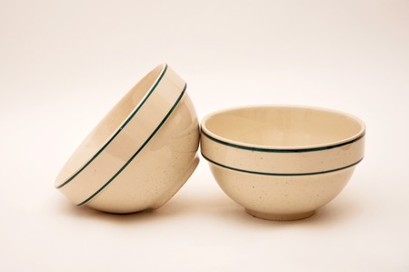 Two empty ceramic bowls with two dark stripes.の写真素材