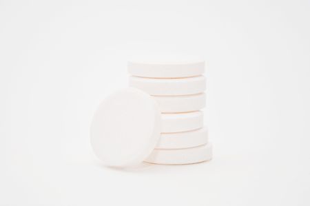 Stacks of multivitamin effervescent tablets, high keyの写真素材