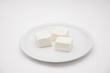 Fresh and tasty goat cheese served on a white plate.の写真素材