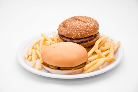 A tasty hamburger, cheeseburger and french fries.の写真素材