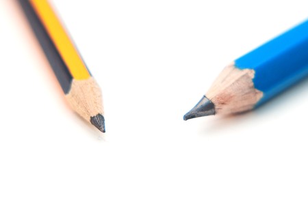 Wooden graphite black and yellow pencils over a white backgroundの写真素材