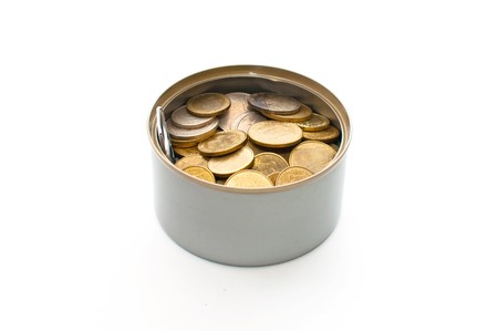 Coins in a aluminum can over a white backgroundの写真素材