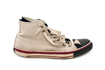 old, dirty sneakers over white backgroundの写真素材