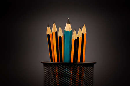 Pencils in a pen holder over a dark backgroundの写真素材