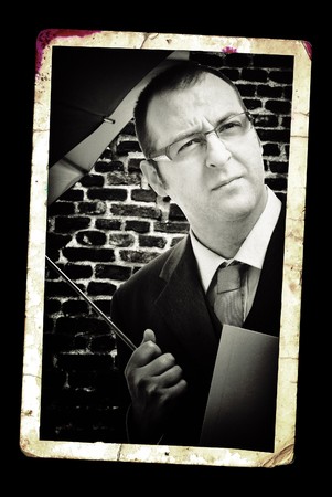 Businessman with umbrella, classic black and white portrait.