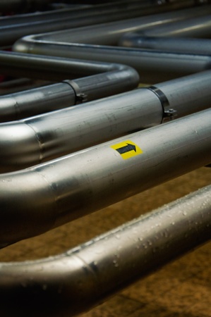 Modern brewery - workshop with steel tanks and pipesの写真素材