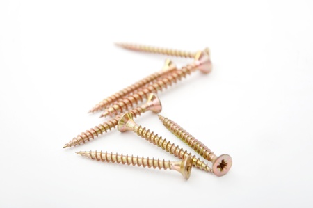 A yellow wood screw over a white backgroundの写真素材