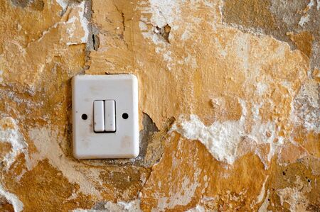 Old light switch on a grungy wallの写真素材