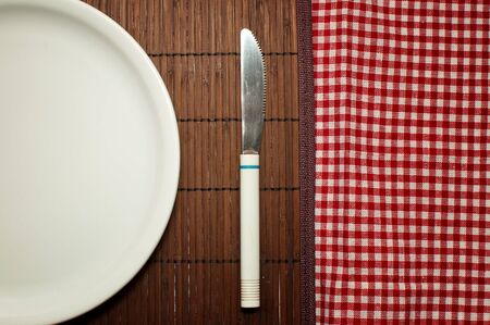 Empty white plate on a kitchen table.の写真素材