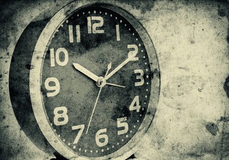 Vintage clock over a grunge paper backgroundの写真素材