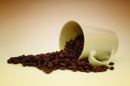 Beautiful brown coffee beans and a coffee mug.の写真素材