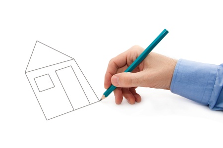 Male hand holding a pencil and drawing a house on a white background.の写真素材