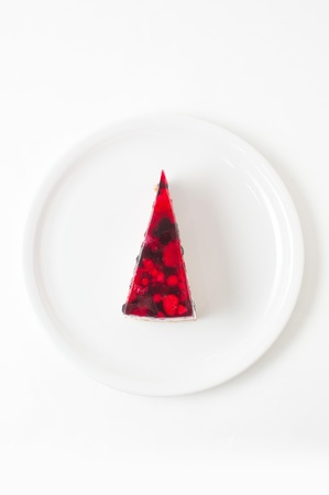 Piece of sweet cheese cake on a white plate.