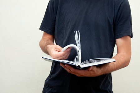 Man holding an opened book in hands.の写真素材