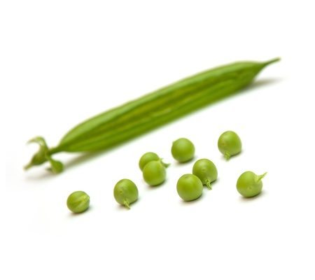 Green peas pods over a white backgroundの写真素材
