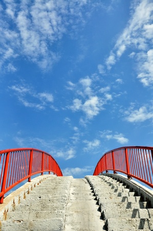 Concrete stairway against a blue sky with cloudsの写真素材