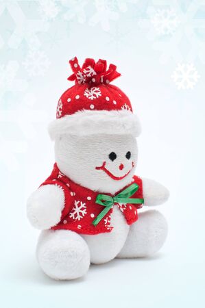 Smiling snowman toy dressed in scarf and capの写真素材