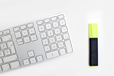 Office desktop, a computer keyboard and a yellow markerの写真素材