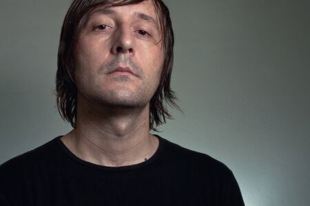 Artistic portrait of a man with a long hair in his 30's.の写真素材