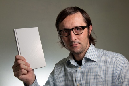 Nerd male holding a book with empty white covers, this image is a humorous concept photo.の写真素材