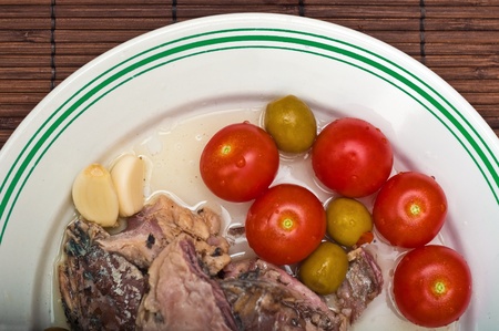 Mackerel with some fresh vegetables on a white plate, close up imageの写真素材