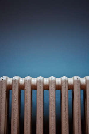 Heating radiator on purple wall in a roomの写真素材