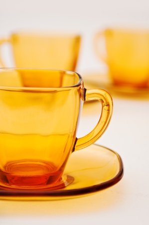 yelllow glass tea cups against the white backgroundの写真素材