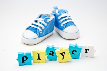Blue baby shoes and a word puzzle pieces forming a word  Playerの写真素材