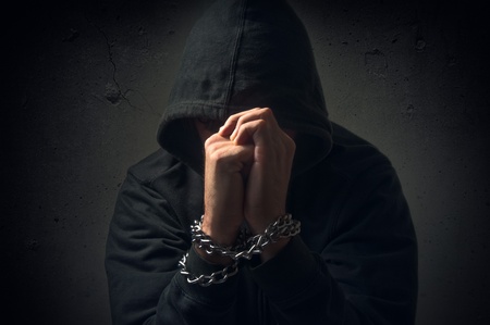 Male hands with chain wrapped around them, prisoner conceptの写真素材